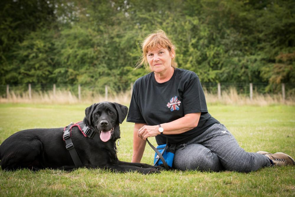 Dionne Worth with black labrador Blake on completing UK Sniffer Dogs accredited instructor course